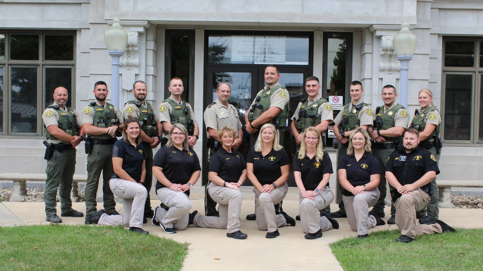 The Chickasaw County Sheriff's Office staff members posing for a photo outside of the county courthouse.